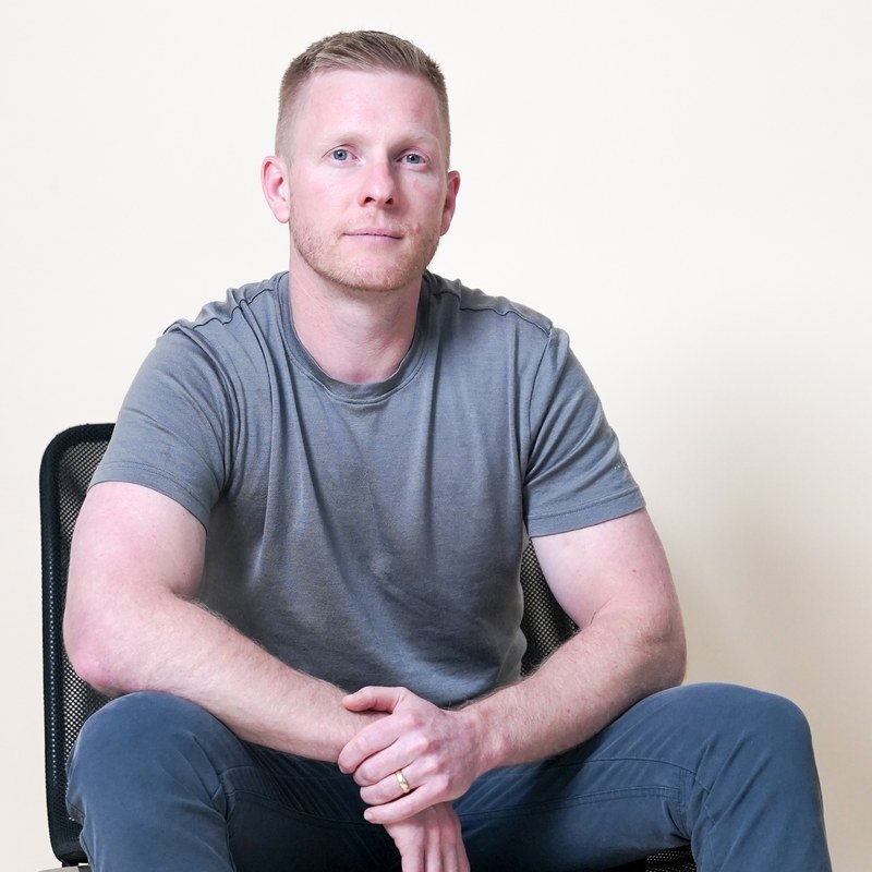 Brent DeMartini, sitting in a chair